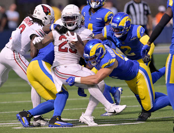 The Los Angeles Rams defense swarms the Cardinals ball carrier